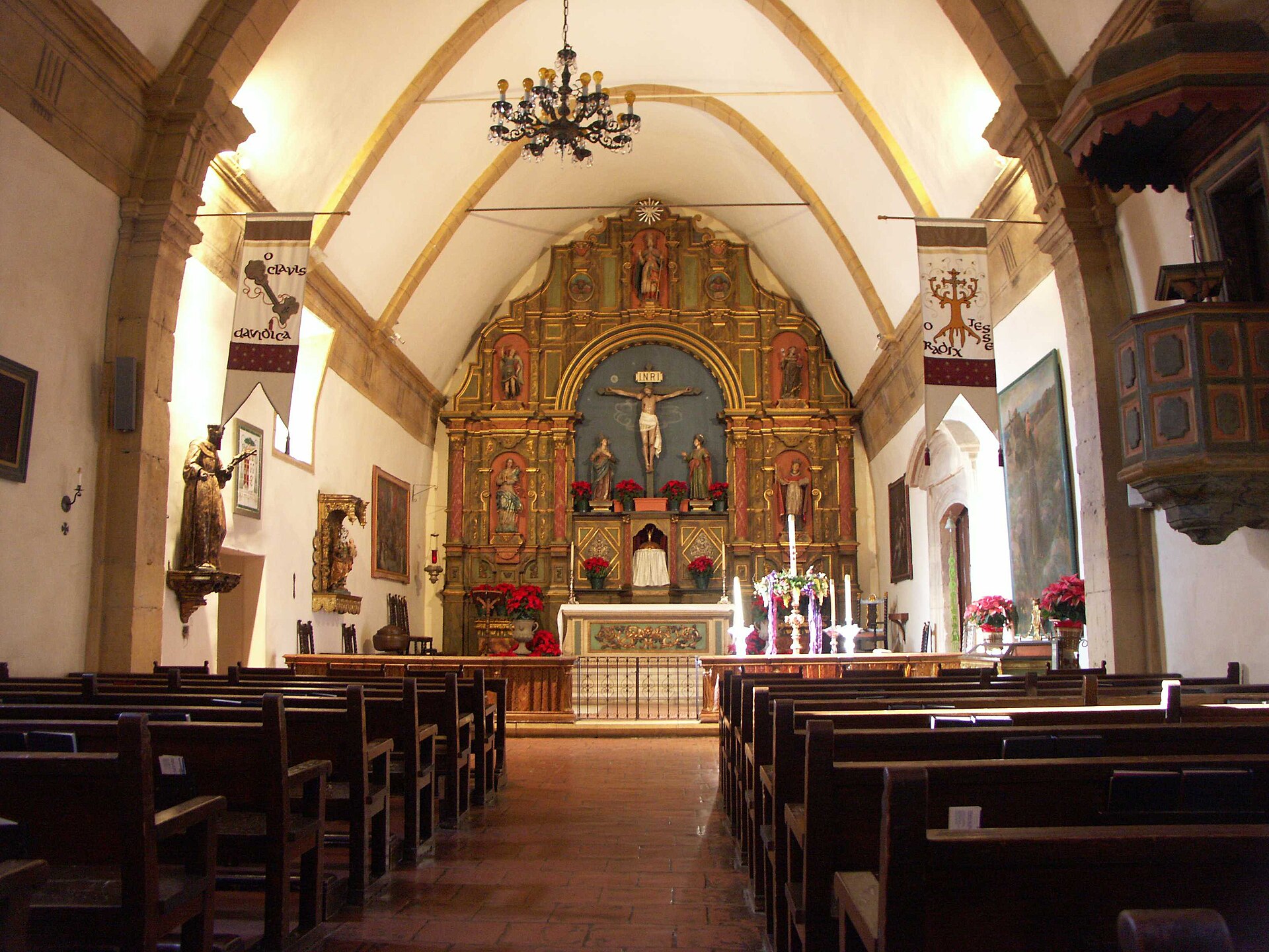 The stone nave and decorated altar of the Carmel Mission Basilica