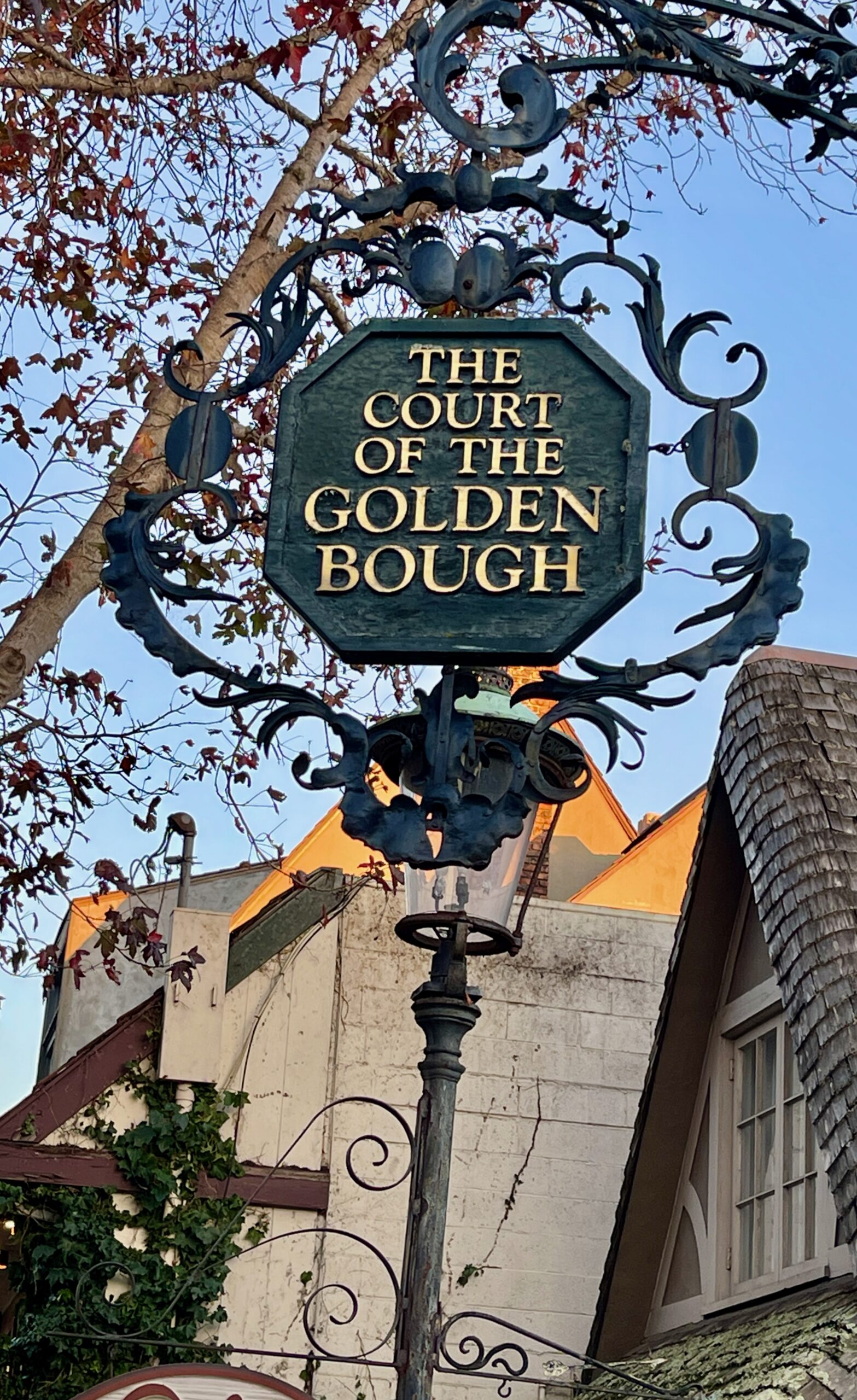 The carved sign marking the entrance to the Court of the Golden Bough in Carmel-by-the-Sea today.