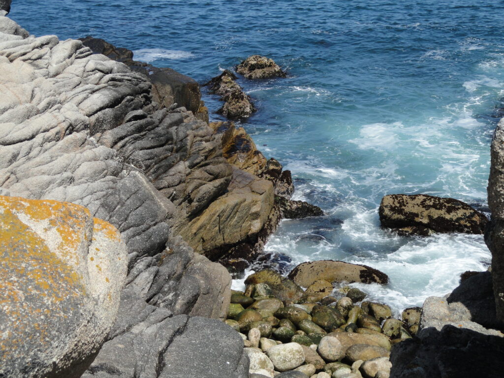 The rocky headland and coves of Lovers Point reaching into Monterey Bay at Pacific Grove.