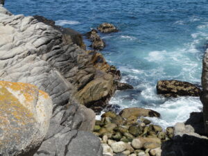 The rocky headland and coves of Lovers Point reaching into Monterey Bay at Pacific Grove.